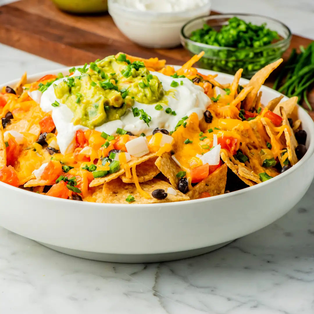 https://instamart-media-assets.swiggy.com/swiggy/image/upload/fl_lossy%2Cf_auto%2Cq_auto%2Ch_960%2Cw_960//InstamartAssets/Receipes/cheesy_nacho_with_salsa.webp